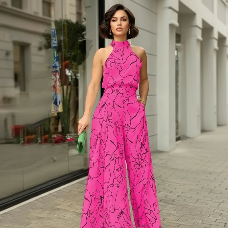Person wearing a bright pink jumpsuit with black abstract patterns on a street.