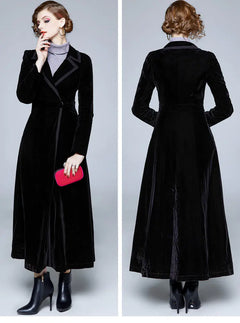 Black velvet coat worn by a model on a plain background
