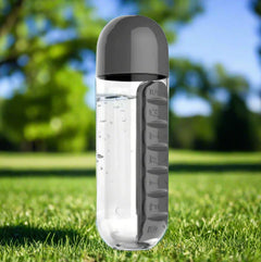 Clear water bottle with a dark gray cap and label on a white background