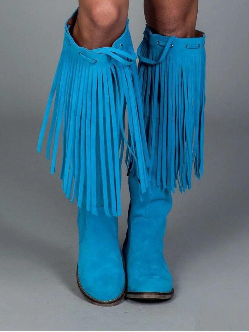 Blue fringed boots on a gray background