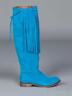 Blue suede boot with fringes on a gray background