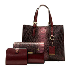 Set of redish leather handbags with gold accents on a white background