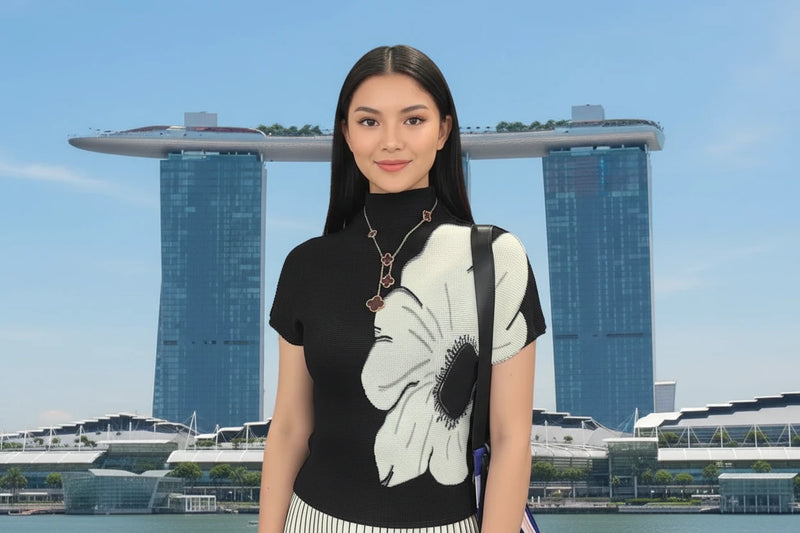 Woman wearing a black top with a white flower design
