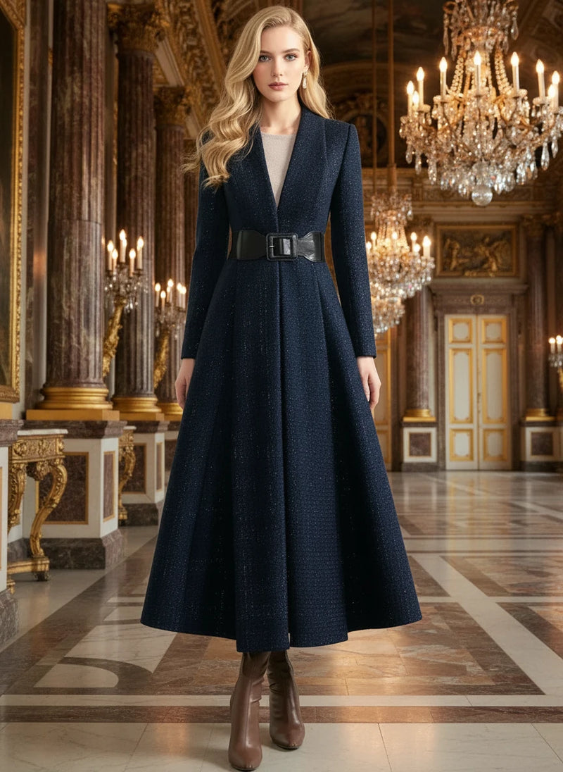 Woman wearing a long navy coat with a belt against a white background