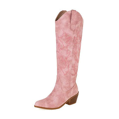 A pair of pink V cut western cowboy boots for women with pointed toes and chunky heels.
